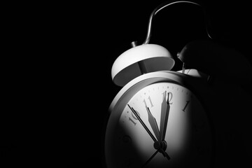 Alarm clock on black background, closeup