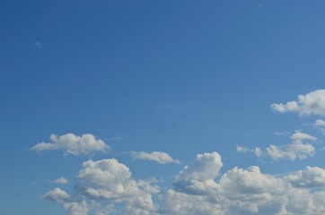 white cloud shapes on blue summer sky