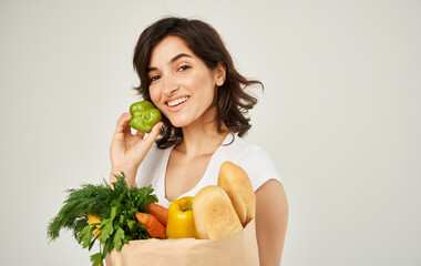 cheerful woman with a package of healthy food fresh products