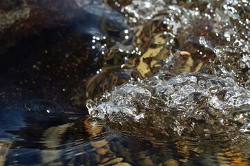 beautiful clean water river flow with air bubbles closeup 