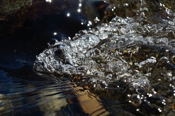 beautiful clean water river flow with air bubbles closeup 