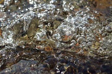 beautiful clean water river flow with air bubbles closeup 