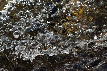 beautiful clean water river flow with air bubbles closeup 