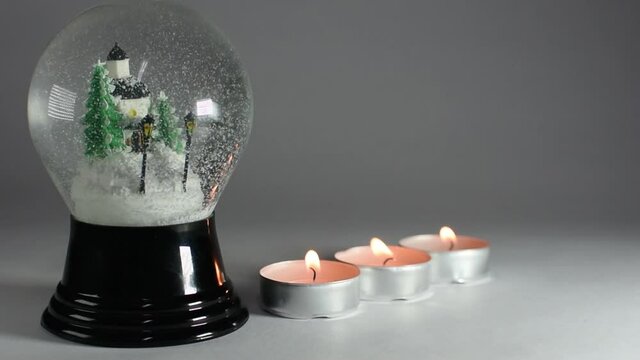 snow globe and candles in a row