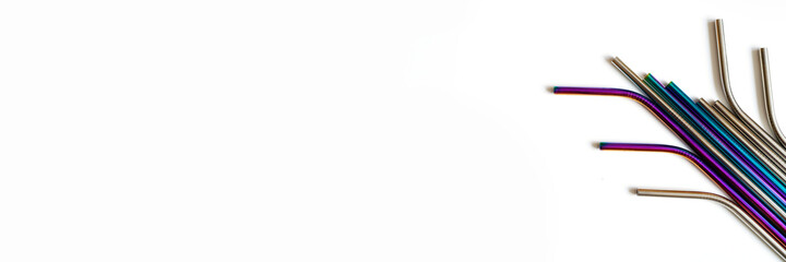 several reusable metal stainless steel drinking straws on a white background. space for text. banner