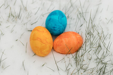 three easter eggs in the snow