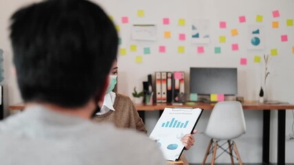 business worker meeting and brainstorm for startup new business. man and woman wear protective face mask in new normal office preventing coronavirus COVID-19 spreading. New normal business concept. - Powered by Adobe