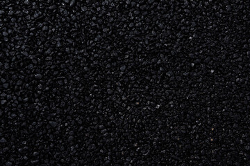 Japanese asphalt pavement with a beautiful black texture and lit with a soft light.