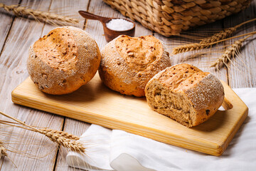 Composition with loafs s of wheat bread on the wooden table