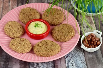 Pinto bean patties with mayonnaise mustard dip garnish with chives