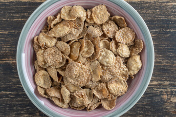 Whole grain glazed flakes in plate. Healthy breakfast, whole grain muesli in a bowl
