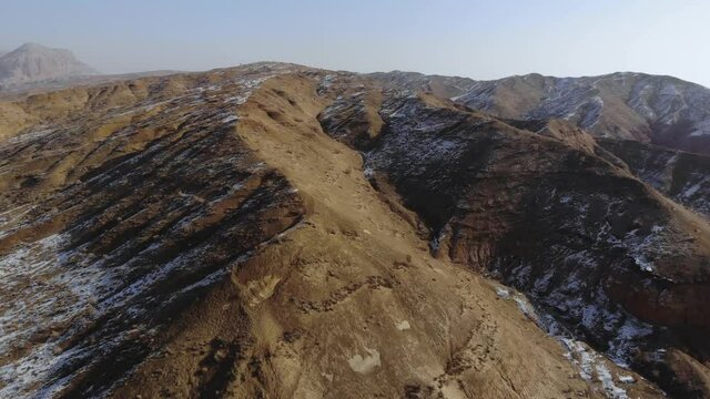 arid desert mountains.
Aerial view from drones to dry mountains. Vast open desert landscape. Clay mountains
Earth destroyed by erosion and global warming - concept of ecological problems 4k footage