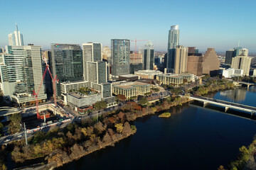Fototapeta premium Aerial view of downtown Austin along the Colorado River at sunset 