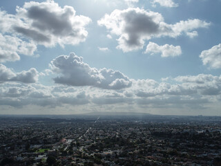 Fototapeta premium Aerial view of the LA basin with the sun streaking through the clouds