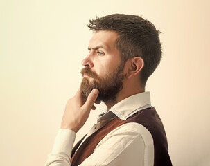 Hipster in shirt and waistcoat. Guy or bearded businessman thinking. Man with beard and mustache on...