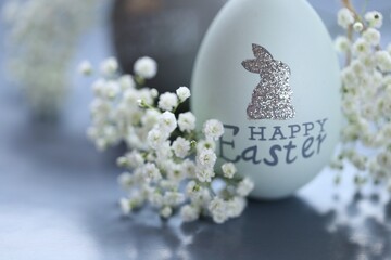 Easter holiday.Easter eggs in gentle gray tones and white gypsophila flowers.Spring festive easter...
