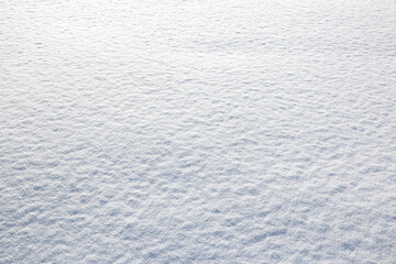 White snow winter texture. Seasonal fresh white color snow nature backdrop wallpaper.  Crisp shiny  frosty snow on sunny day outdoor.