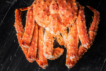 Tasty king kamchatka crab on wood board at brown background