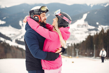 Fototapeta na wymiar Couple in sport clothes. People spending winter vacation on mountains