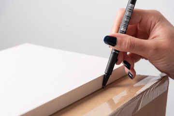 Hand drawing line with ruler on carton box with copy space