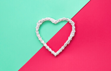 Rustic wooden white heart on colorfull backgrond. Green and red layout.