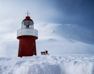 red lighthouse in the snow