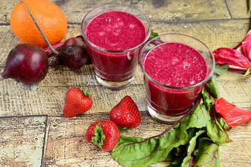 Healthy smoothie made from beetroot, strawberry, orange, beetroot leaves