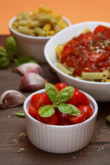 Bowl with tiny tomatoes decorated with basil leaves