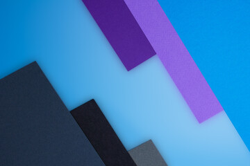 Blue purple black and gray colored textured paper on a blue background