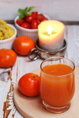 Glass of orange juice and a fresh fruits on the table.