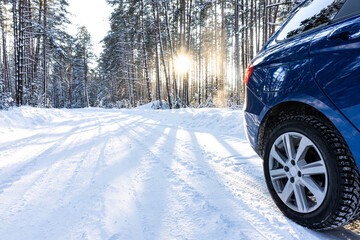 car on a winter road in a snowy forest, winter journey