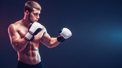 shirtless boxer with gloves on dark background. Isolate