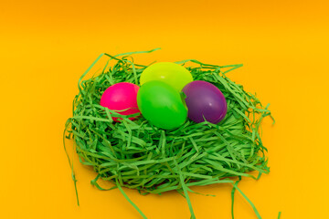 Four Colorful Easter Eggs Sitting in Green nest or Grass