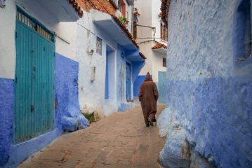 Fotobehang Walking man in CHEFCHAOUEN, MOROCCO. Beautiful view of the blue city in the medina. © mitzo_bs