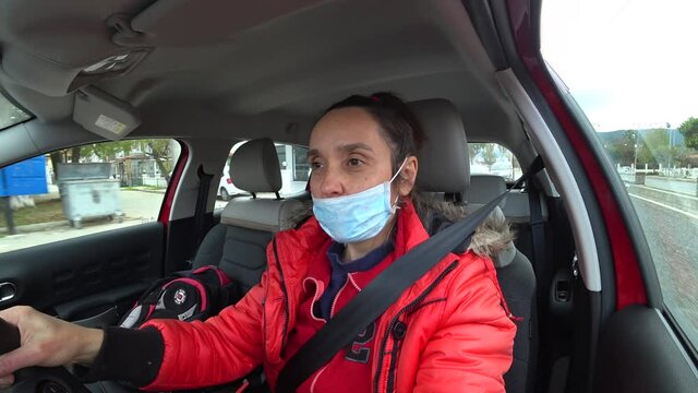 Fethiye, Turkey - 18th of February 2021: 4K Woman in face mask drives her car 