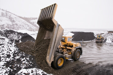 A mining dump truck in an industrial mountainous area in the process. Mining © Letopisec