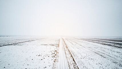 Fototapeta na wymiar snow on a large empty road in winter