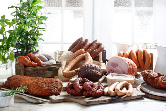 Horizontal view of a rustic composition of homemade, smoked cold cuts.