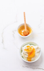Greek yoghurt with honey on marble table