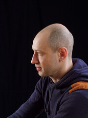 Fototapeta premium portrait of a bald man on a black background