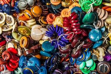 Italy, Apulia, Metropolitan City of Bari, Locorotondo. Buttons for sale in an outdoor market.