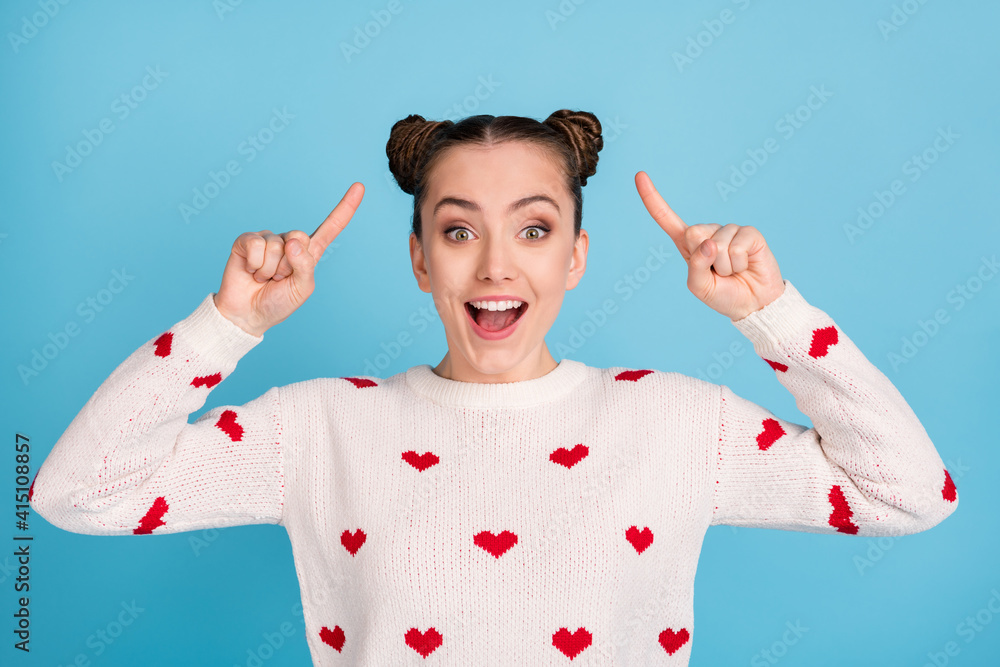 Sticker photo of crazy young lady direct fingers hairstyle wear heart print pullover isolated blue color bac