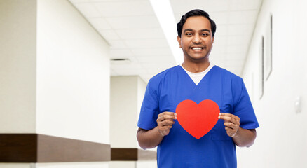 healthcare, profession and medicine concept - happy smiling indian doctor or male nurse in blue...