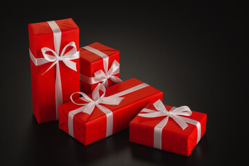 Composition of four gifts of different shapes wrapped in red wrapping paper with a white ribbon and a bow on a black background. Side view. Copy space.