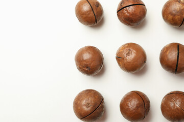 Flat lay with tasty macadamia nuts on white background