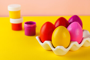 The concept of painting Easter eggs. Bright Easter eggs, paint cans. Happy Easter. Copy space.