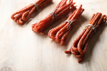 Kabanosy. Traditional smoked thin, dry meat sausages, top view.