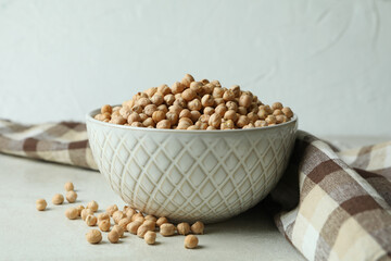 Bowl with chickpea on white textured table with kitchen towel