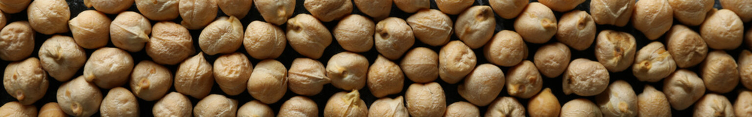 Fresh chickpea on black textured background, space for text