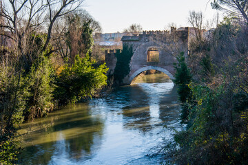 Fototapeta na wymiar Medieval bridge in Rome,The Ponte Nomentano (Ponte Tazio) over the river Aniene